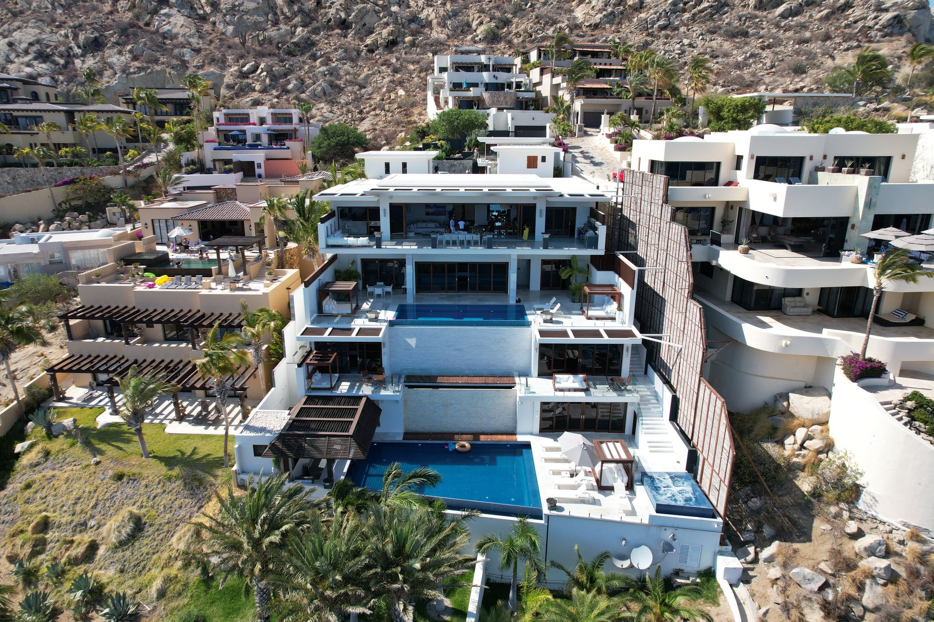 Aerial view of hillside villas with pools in Cabo San Lucas — Virestia operations briefing on CFE electricity tariffs